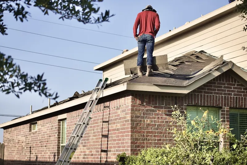 Professional roofer working on a residential roof in Upper Reese